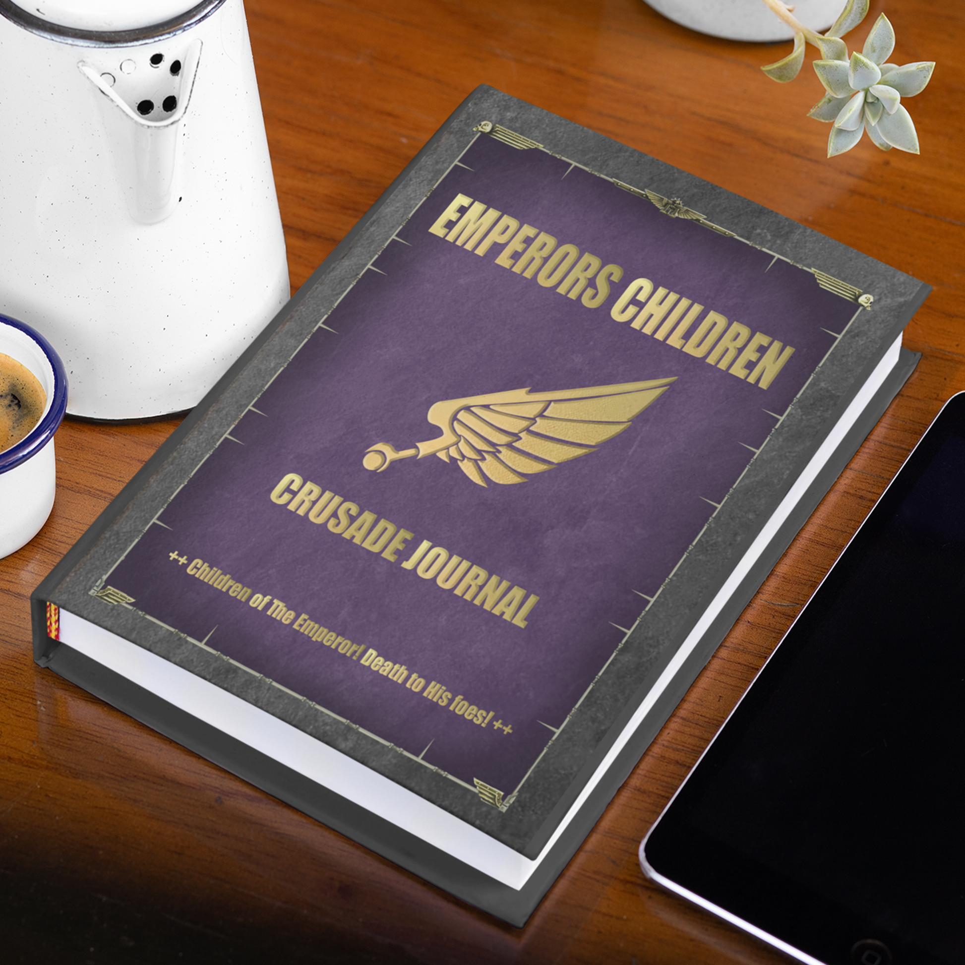Book titled 'Emperors Children Crusade Journal' on a wooden surface with a phone and coffee cup in the background.